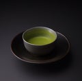 Matcha tea in the cup isolated on black background. Japanese tea ceremony concept. Royalty Free Stock Photo