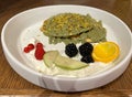 Matcha tea green pancakes. Pile of homemade pancakes with fresh raspberries and pistachios