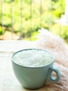 Matcha tea latte morning antioxidant hot drink in blue cup on yellow table cloth with pampas grass Royalty Free Stock Photo