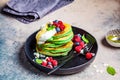 Matcha tea pancakes with berries, dark background, copy space. Healthy vegan food concept Royalty Free Stock Photo