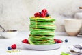 Matcha tea pancakes with berries, white background. Healthy vegan food concept Royalty Free Stock Photo