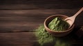 Matcha tea powder in wooden bowl and spoon on wooden background.