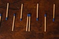 Matches with the match part or blue head, grouped on a wooden table. 5