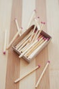 Matches in an open box on a striped wooden table Royalty Free Stock Photo
