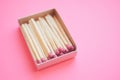 Matches in open paper box on a pale pink table Royalty Free Stock Photo