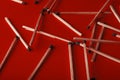 Matches on a red background, an abstraction about teamwork and modern relationships