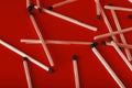 Matches on a red background, an abstraction about teamwork and modern relationships