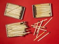 Matches on a red background. Safe handling of fire. Fire dangers. Lots of matches Royalty Free Stock Photo