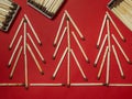 Matches on a red background. Safe handling of fire. Fire dangers. Lots of matches. Pictures lined with matches. Trees of matches