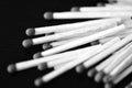 Matches scattered on a dark background. Black and white Royalty Free Stock Photo