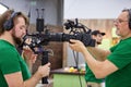 Matching cameras on the set. Behind the scenes of movie shooting or video production and film crew team with camera Royalty Free Stock Photo