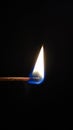 Matchstick flame in a black background, perfect for phone wallpapers. Royalty Free Stock Photo