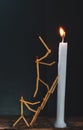 Matchsticks in form of a man lighting a candle, matchstick man lighting a candle. Royalty Free Stock Photo