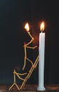 Matchsticks in form of a man lighting a candle, matchstick man lighting a candle. Royalty Free Stock Photo