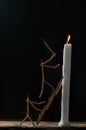 Matchsticks in form of a man lighting a candle, matchstick man lighting a candle. Royalty Free Stock Photo