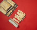 Matchsticks on a red background. Safe handling of fire. Fire dangers. Lots of matches. household still life