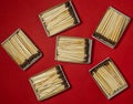 Matchsticks on a red background. Safe handling of fire. Fire dangers. Lots of matches. household still life