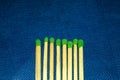 Matchsticks with a red heads with heart shaped match among others on a classic blue background Royalty Free Stock Photo