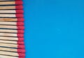 Matchsticks in a row over blue background. Royalty Free Stock Photo