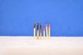 Matchsticks. Set of burnt matchsticks and matches without burning on blue background. The spread of fire in conceptual photo in co Royalty Free Stock Photo