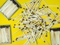 Matchsticks on a yellow background. Safe handling of fire. Fire dangers. Lots of matches. household still life