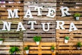 Mater natura mother nature text green thumb pallets wooden background