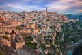 Matera, Basilicata, Italy: landscape at dawn of the old town called Sassi with the ancient cave houses and the creek at the bottom Royalty Free Stock Photo