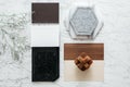 Material Selections including Granite tile, Marble tile, Acoustic tile, Walnut and Ash Wood Laminate with plant on marble top Royalty Free Stock Photo