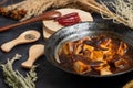 Material of traditional chinese food,spicy Mapo Tofu decorates with chilis and hot peppers on black background Royalty Free Stock Photo