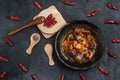 Material of traditional chinese food,spicy Mapo Tofu decorates with chilis and hot peppers on black background Royalty Free Stock Photo