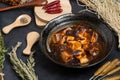 Material of traditional chinese food,spicy Mapo Tofu decorates with chilis and hot peppers on black background Royalty Free Stock Photo