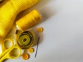 A collection of yellow sewing accessories on a white background Royalty Free Stock Photo