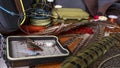 Materials and tools for tying lures on a wooden table. Fly Fishing Still Life. Royalty Free Stock Photo