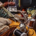 Materials and tools for tying lures on a wooden table. Fly Fishing Still Life Royalty Free Stock Photo