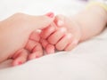 Maternal hand holds her baby. Newborn children`s hand in mother hand. Mom and her Child. Happy Family concept. Beautiful Royalty Free Stock Photo