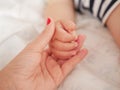 Maternal hand holds her baby. Newborn children`s hand in mother hand. Mom and her Child. Happy Family concept. Beautiful Royalty Free Stock Photo