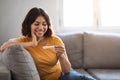 Maternity Concept. Happy Young Arab Woman Holding Positive Pregnancy Test At Home Royalty Free Stock Photo