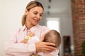 Maternity concept. Mother holding her baby daughter on hands. conforting her, enjoying tender close family moment Royalty Free Stock Photo