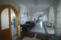 At the maternity department. Doctor holding a newborn baby visible through opened door, nurse sitting in a nurseÃ¢â¬â¢s station