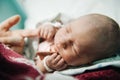 Maternity and parenting. child holds mother by the finger with his small pen Royalty Free Stock Photo