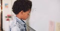 Math class, sad child at board for education, learning and problem solving for skill development. Boy at whiteboard in Royalty Free Stock Photo