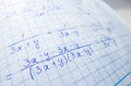 Math formulas are written in a notebook with a pen. The solution of examples and problems in a notebook Royalty Free Stock Photo