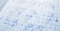 Math formulas are written in a notebook with a pen. The solution of examples and problems in a notebook Royalty Free Stock Photo
