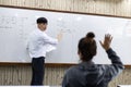 Math or physical teacher is working on teaching high school students in the classroom, opening of the new semester of students
