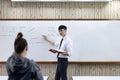 Math or physical teacher is working on teaching high school students in the classroom, opening of the new semester of students