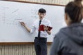 Math or physical teacher is working on teaching high school students in the classroom, opening of the new semester of students