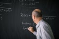 Math teacher drawing fuction graph on a blackboard