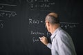 Math teacher drawing fuction graph on a blackboard