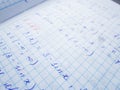 Math formulas are written in a notebook with a pen. The solution of examples and problems in a notebook Royalty Free Stock Photo