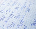 Math formulas are written in a notebook with a pen. The solution of examples and problems in a notebook Royalty Free Stock Photo